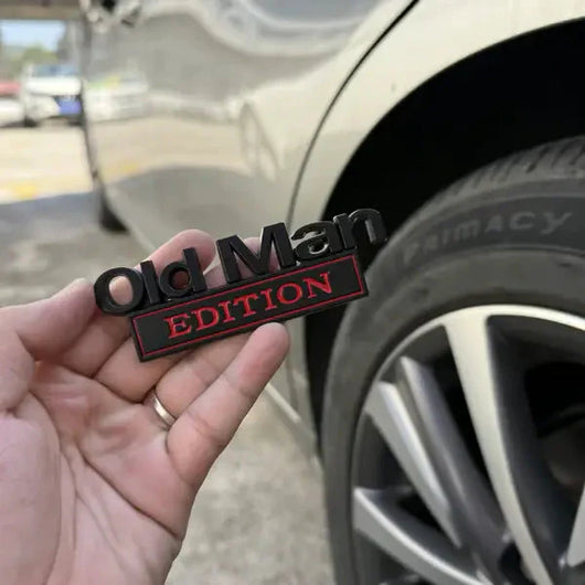 Old Man Edition badge in hand at steering wheel